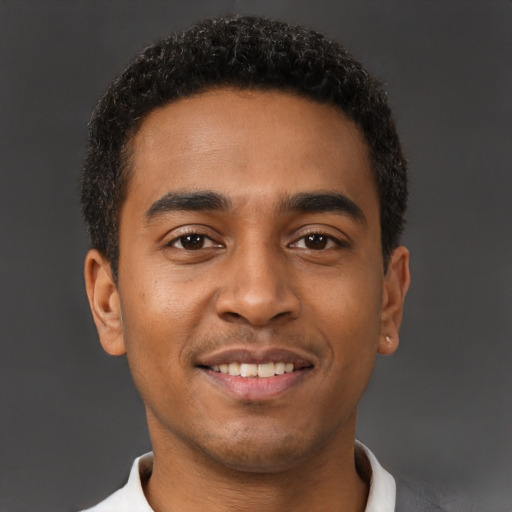 Joyful latino young-adult male with short  brown hair and brown eyes