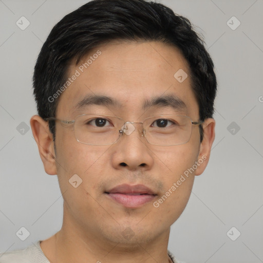 Joyful asian young-adult male with short  brown hair and brown eyes