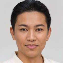 Joyful asian young-adult male with short  brown hair and brown eyes