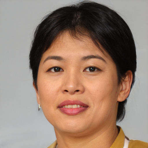 Joyful asian adult female with short  brown hair and brown eyes