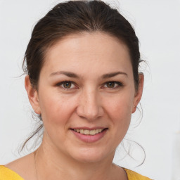 Joyful white young-adult female with medium  brown hair and brown eyes