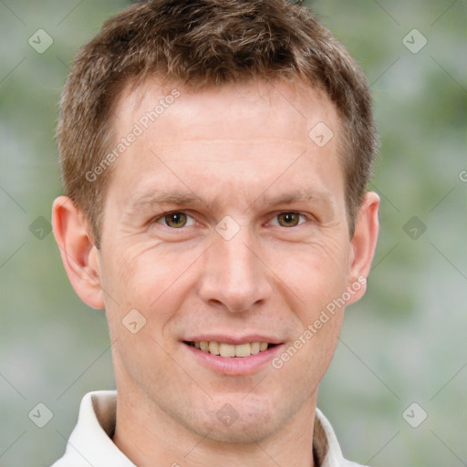 Joyful white adult male with short  brown hair and grey eyes