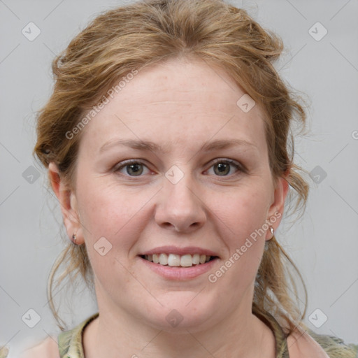 Joyful white young-adult female with medium  brown hair and blue eyes