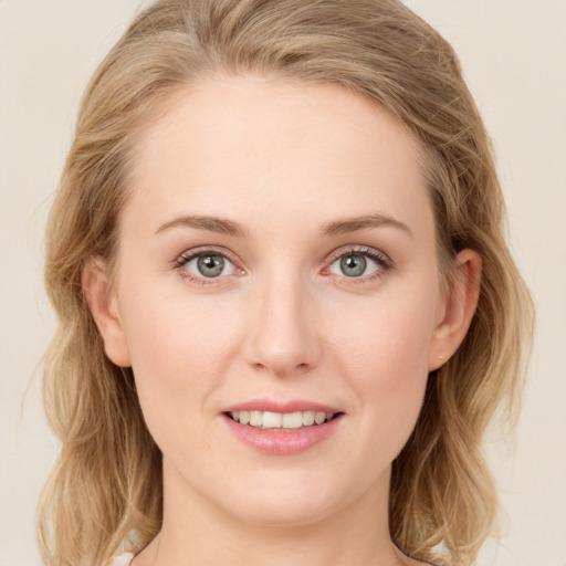 Joyful white young-adult female with long  brown hair and blue eyes