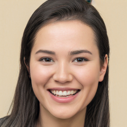 Joyful white young-adult female with long  brown hair and brown eyes