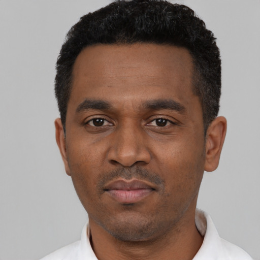 Neutral black young-adult male with short  black hair and brown eyes