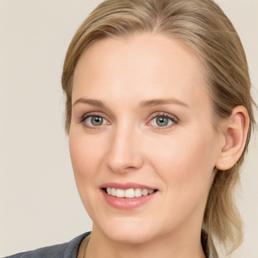 Joyful white young-adult female with medium  brown hair and blue eyes