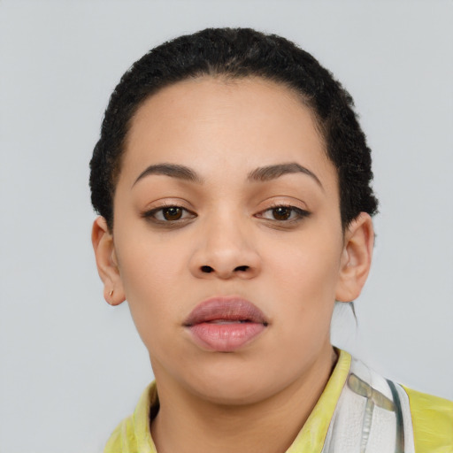Joyful latino young-adult female with short  black hair and brown eyes
