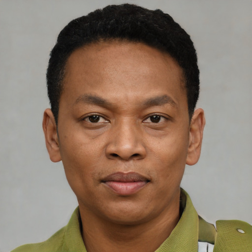Joyful black young-adult male with short  black hair and brown eyes