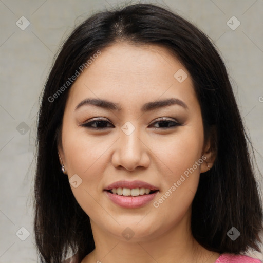 Joyful asian young-adult female with long  brown hair and brown eyes