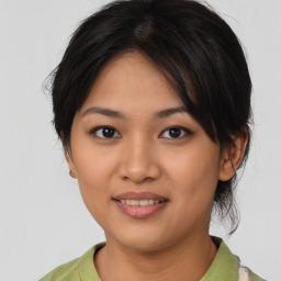 Joyful asian young-adult female with medium  black hair and brown eyes