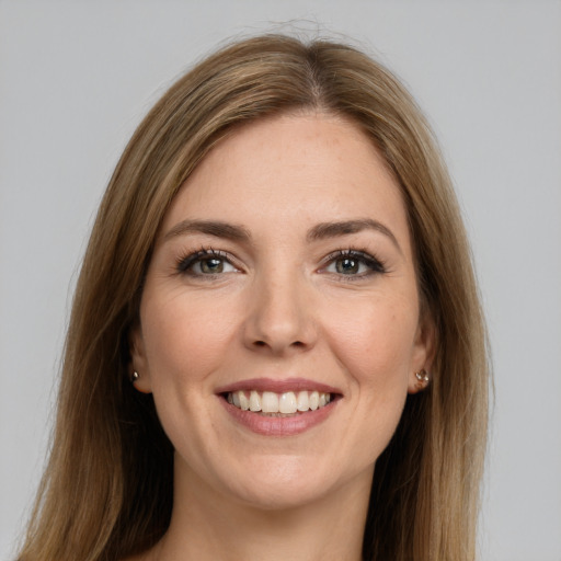 Joyful white young-adult female with long  brown hair and brown eyes