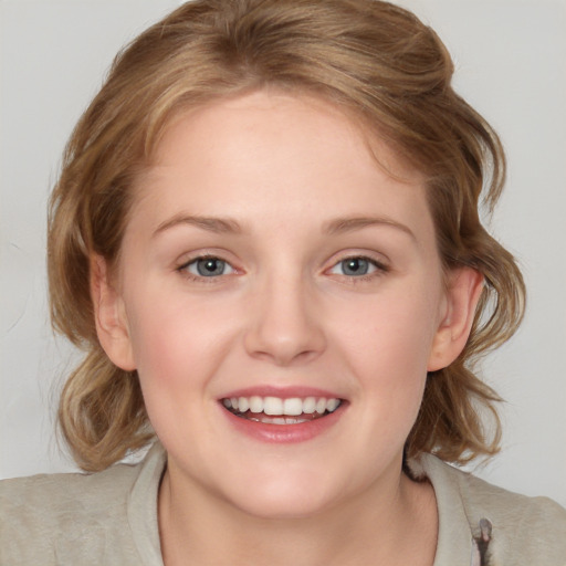 Joyful white young-adult female with medium  brown hair and blue eyes