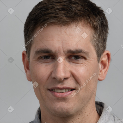 Joyful white adult male with short  brown hair and grey eyes