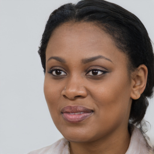 Joyful black young-adult female with medium  brown hair and brown eyes