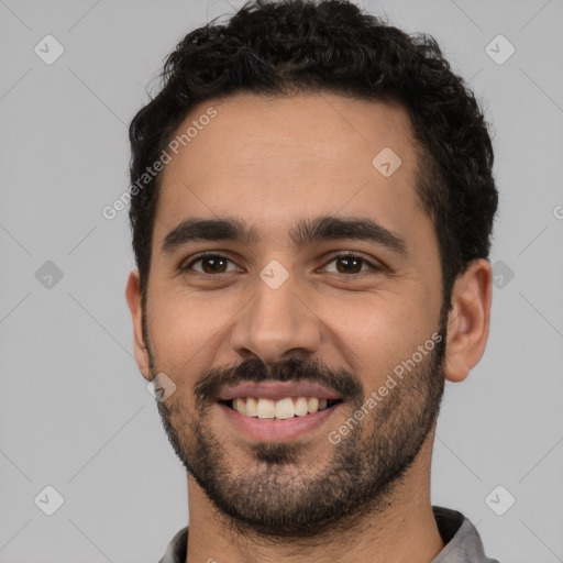 Joyful white young-adult male with short  black hair and brown eyes