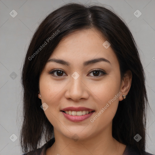 Joyful asian young-adult female with long  brown hair and brown eyes