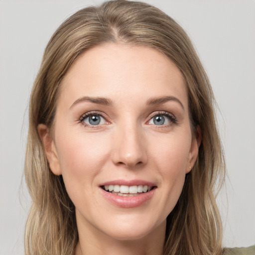 Joyful white young-adult female with medium  brown hair and green eyes