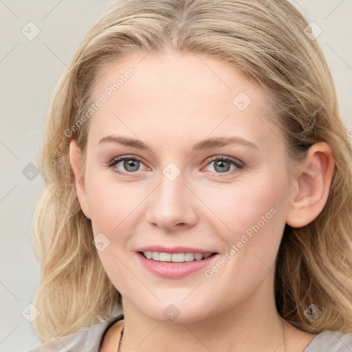 Joyful white young-adult female with medium  brown hair and blue eyes