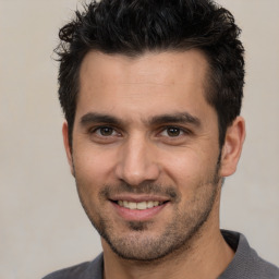 Joyful white young-adult male with short  black hair and brown eyes