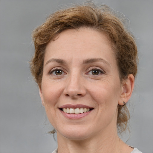 Joyful white adult female with medium  brown hair and grey eyes