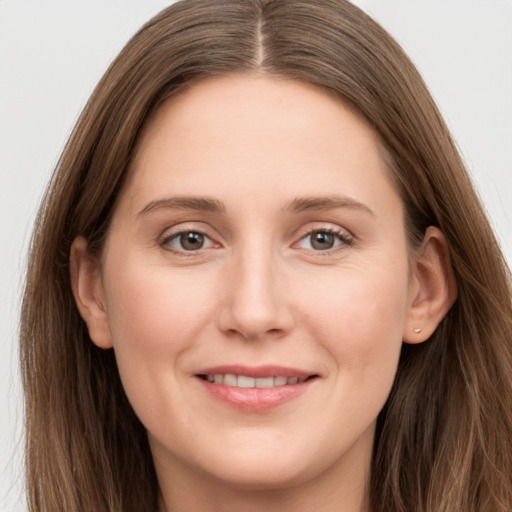 Joyful white young-adult female with long  brown hair and grey eyes