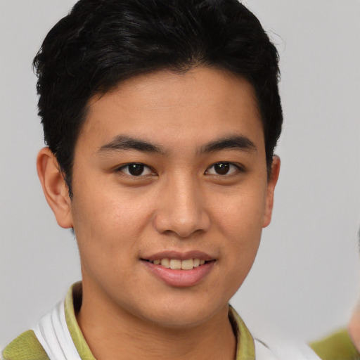 Joyful latino young-adult male with short  brown hair and brown eyes