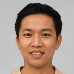 Joyful asian young-adult male with short  black hair and brown eyes