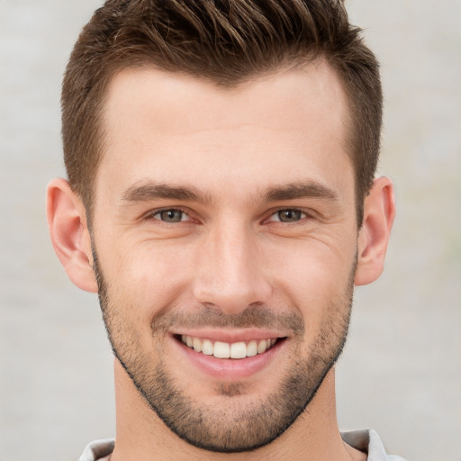 Joyful white young-adult male with short  brown hair and brown eyes