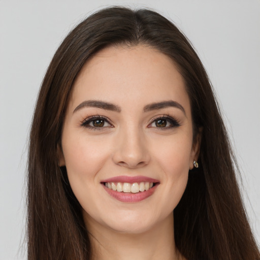 Joyful white young-adult female with long  brown hair and brown eyes