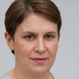 Joyful white adult female with short  brown hair and grey eyes