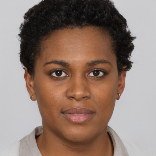Joyful black young-adult female with short  brown hair and brown eyes