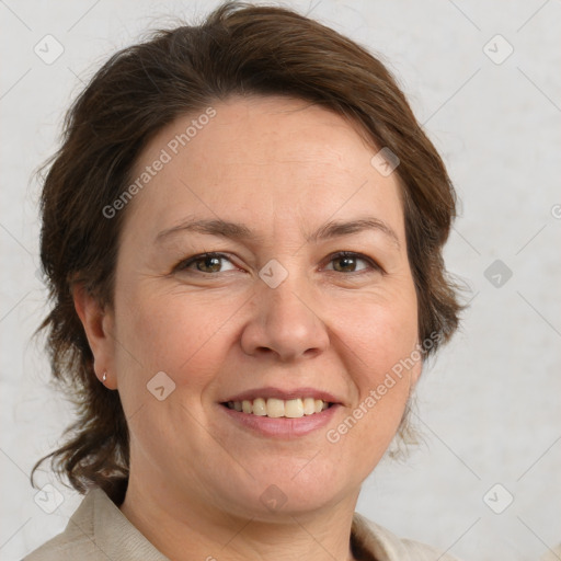 Joyful white adult female with medium  brown hair and grey eyes