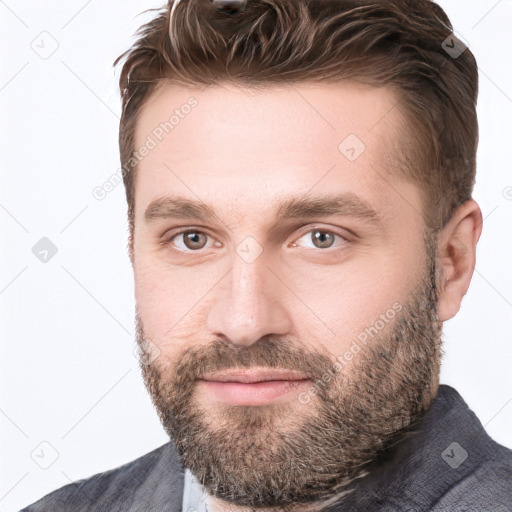 Joyful white young-adult male with short  brown hair and grey eyes