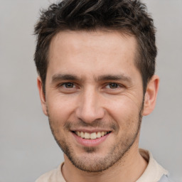 Joyful white young-adult male with short  brown hair and brown eyes