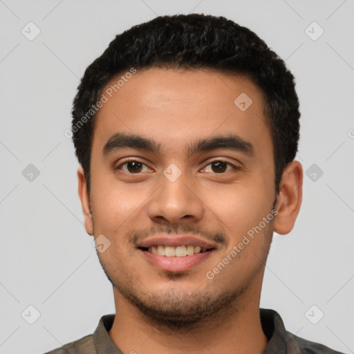 Joyful latino young-adult male with short  black hair and brown eyes