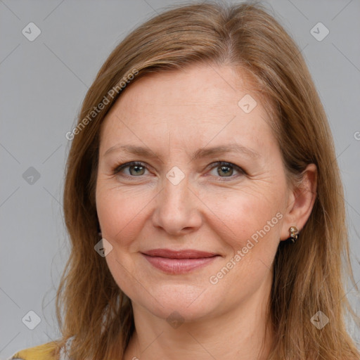 Joyful white adult female with long  brown hair and brown eyes