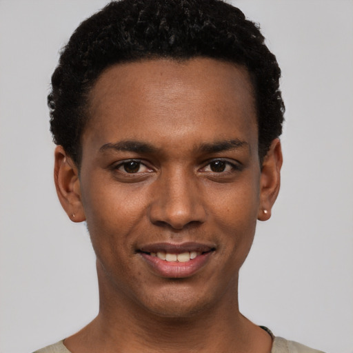 Joyful black young-adult male with short  black hair and brown eyes