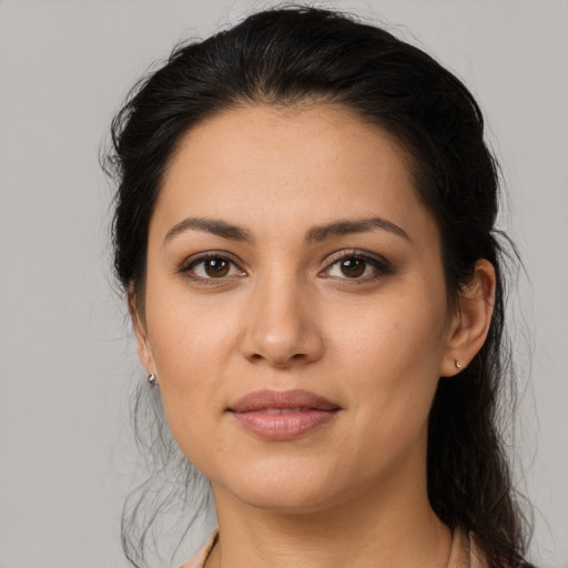 Joyful latino young-adult female with medium  brown hair and brown eyes