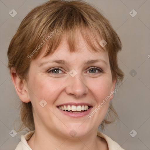 Joyful white adult female with medium  brown hair and blue eyes