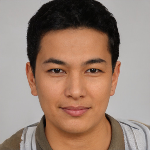 Joyful latino young-adult male with short  black hair and brown eyes