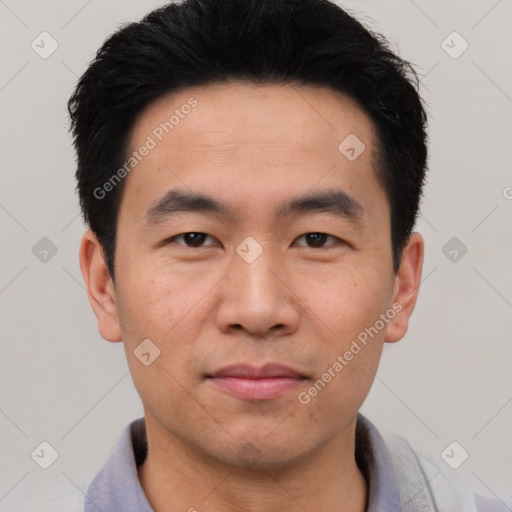 Joyful asian young-adult male with short  black hair and brown eyes