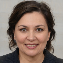 Joyful white adult female with medium  brown hair and brown eyes