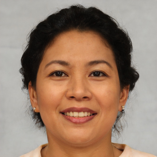 Joyful latino adult female with short  brown hair and brown eyes