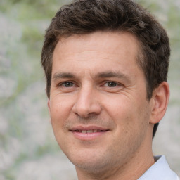 Joyful white adult male with short  brown hair and brown eyes