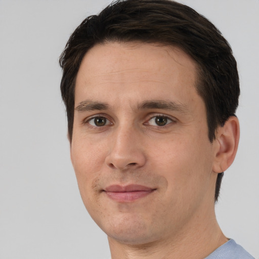 Joyful white adult male with short  brown hair and brown eyes