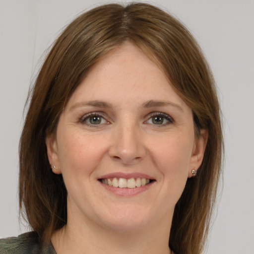 Joyful white young-adult female with medium  brown hair and grey eyes