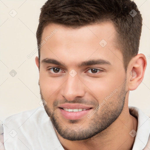 Joyful white young-adult male with short  brown hair and brown eyes