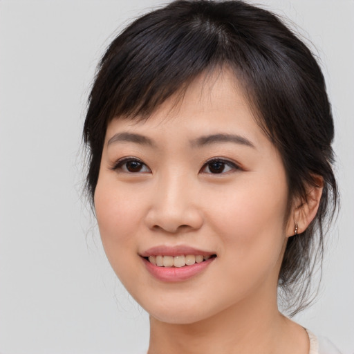 Joyful asian young-adult female with medium  brown hair and brown eyes