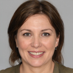 Joyful white adult female with medium  brown hair and brown eyes